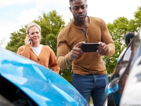 motorist-involved-in-car-accident-taking-picture-of-damage-for-insurance-claim-1.jpg
